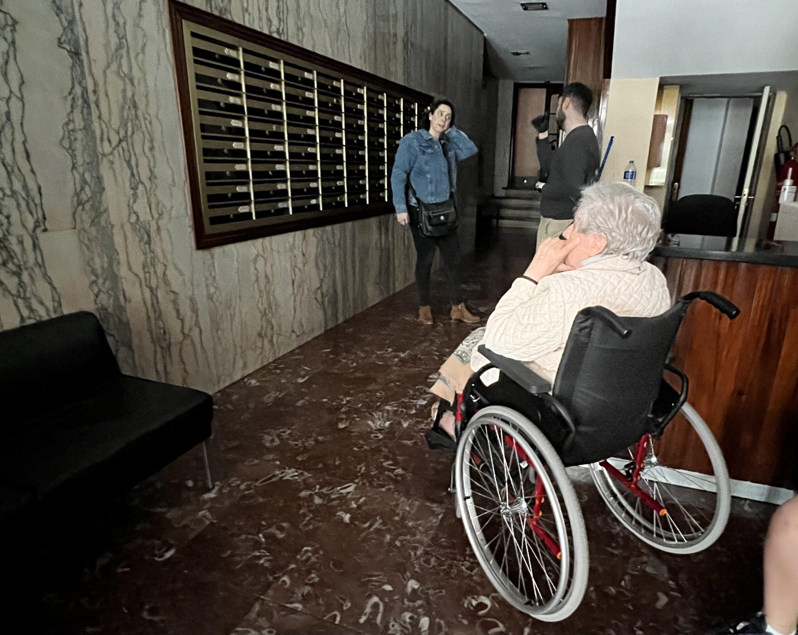 En la imagen, una mujer en silla de ruedas no puede acceder a su vivienda.